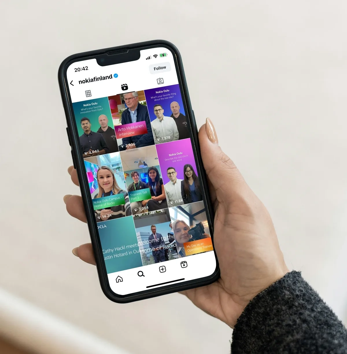 Hand holding mobile phone with instagram feed open