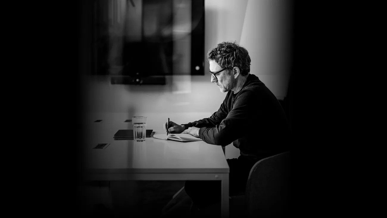 Man sitting alone in a meeting room with laptop