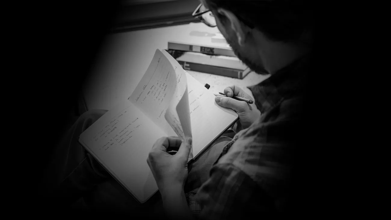 Hands holding a notebook
