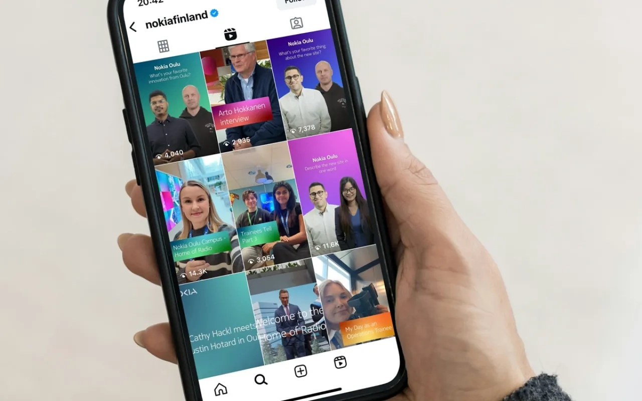 Hand holding mobile phone with instagram feed open