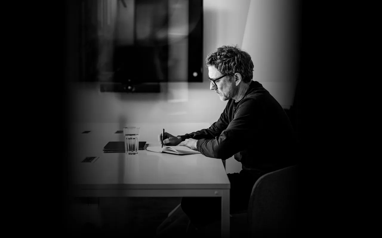 Man sitting alone in a meeting room with laptop